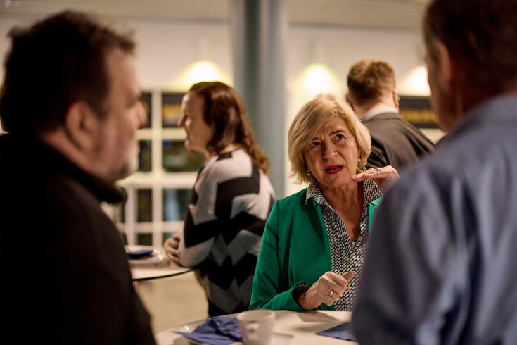 Older woman talking to two men